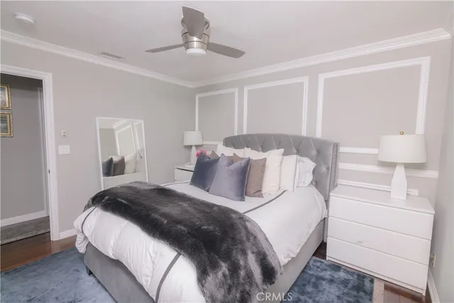 a bedroom with a large bed and a chandelier