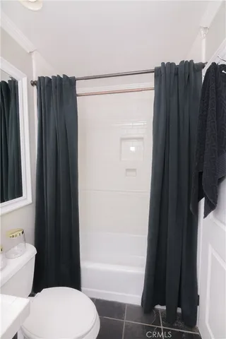 a bathroom with a toilet a sink and shower