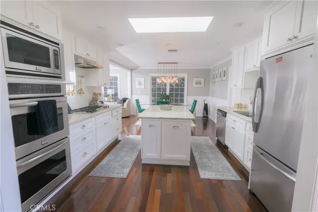 a kitchen with a sink stainless steel appliances and cabinets