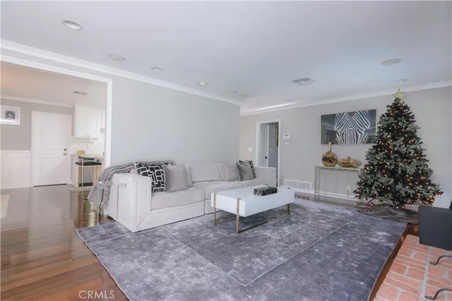 a living room with furniture plant and a window