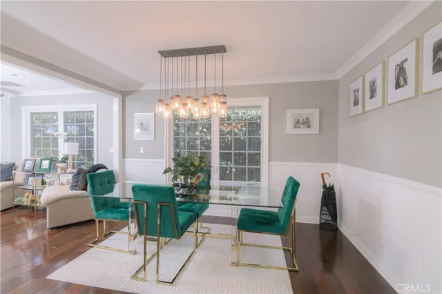 a living room with furniture potted plant and a large window