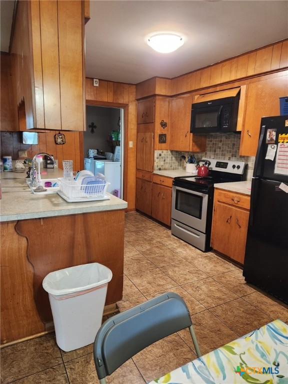 306 Dover Street Victoria, TX 77905 - Photo 11 of 20 a kitchen with stainless steel appliances granite countertop a sink a stove a microwave a dining table and chairs