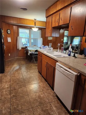 a kitchen with a sink and cabinets