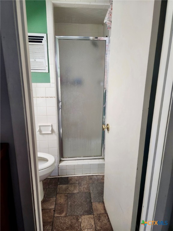 306 Dover Street Victoria, TX 77905 - Photo 17 of 20 a bathroom with a toilet and a glass door shower