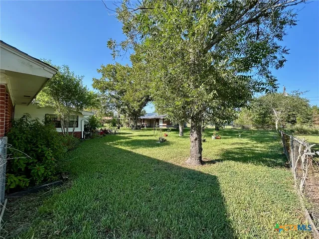 a view of a park with large trees