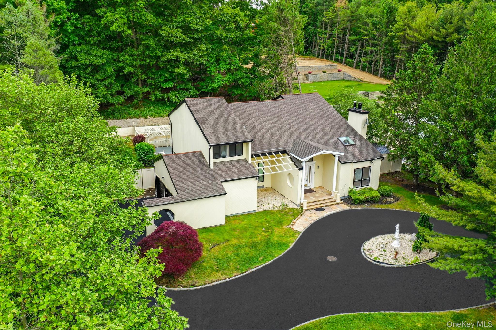 126 Bagatelle Road Melville, NY 11747 - Photo 5 of 50 a view of a house with a yard and patio
