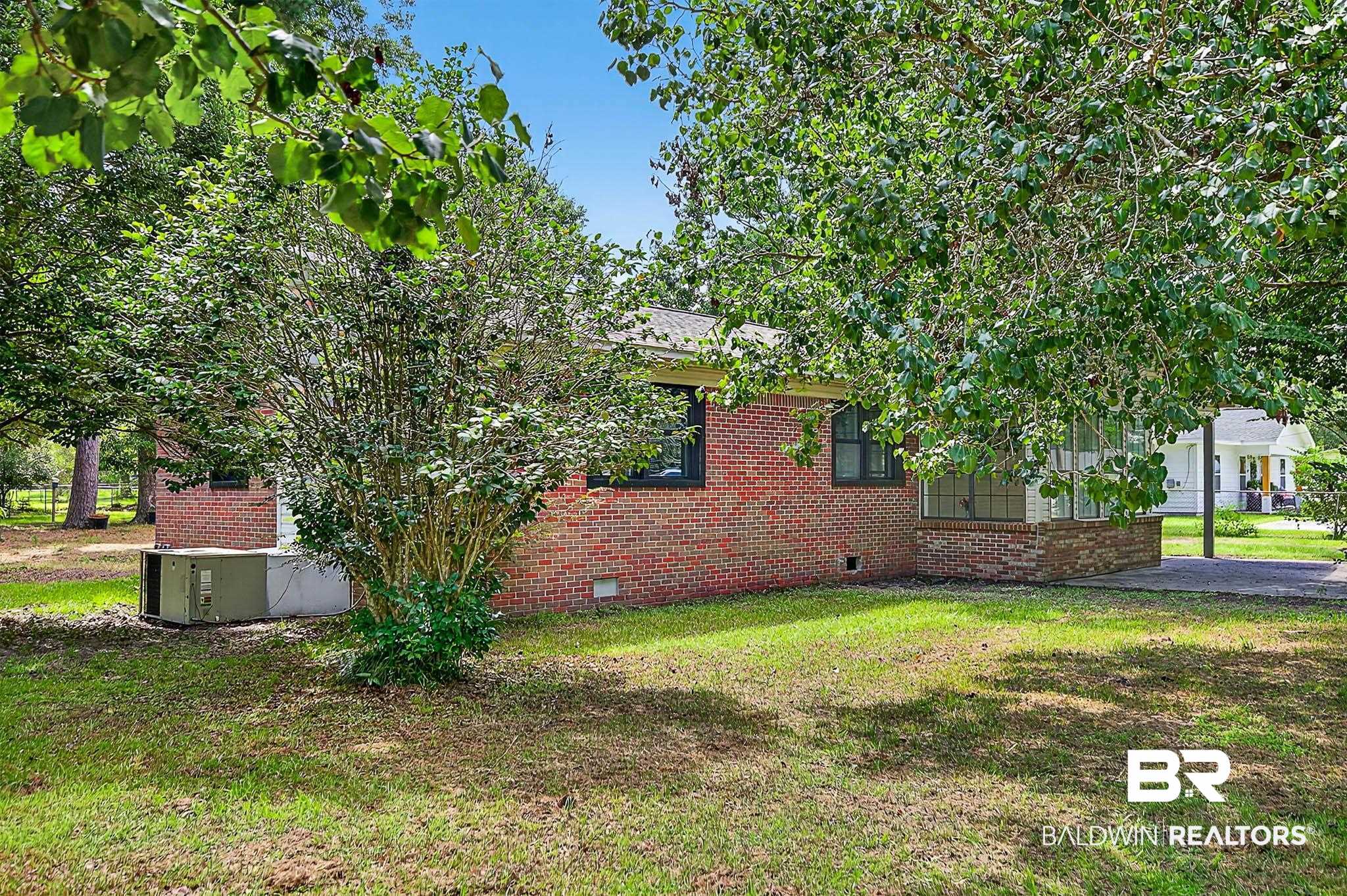 101 Terry Avenue Brewton, AL 36426 - Photo 21 of 48 View of side of home featuring brick siding, crawl space, and a lawn