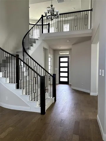a view of staircase with white walls and a window