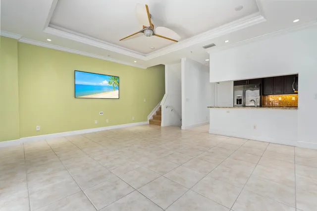a view of kitchen with stainless steel appliances granite countertop white cabinets and refrigerator