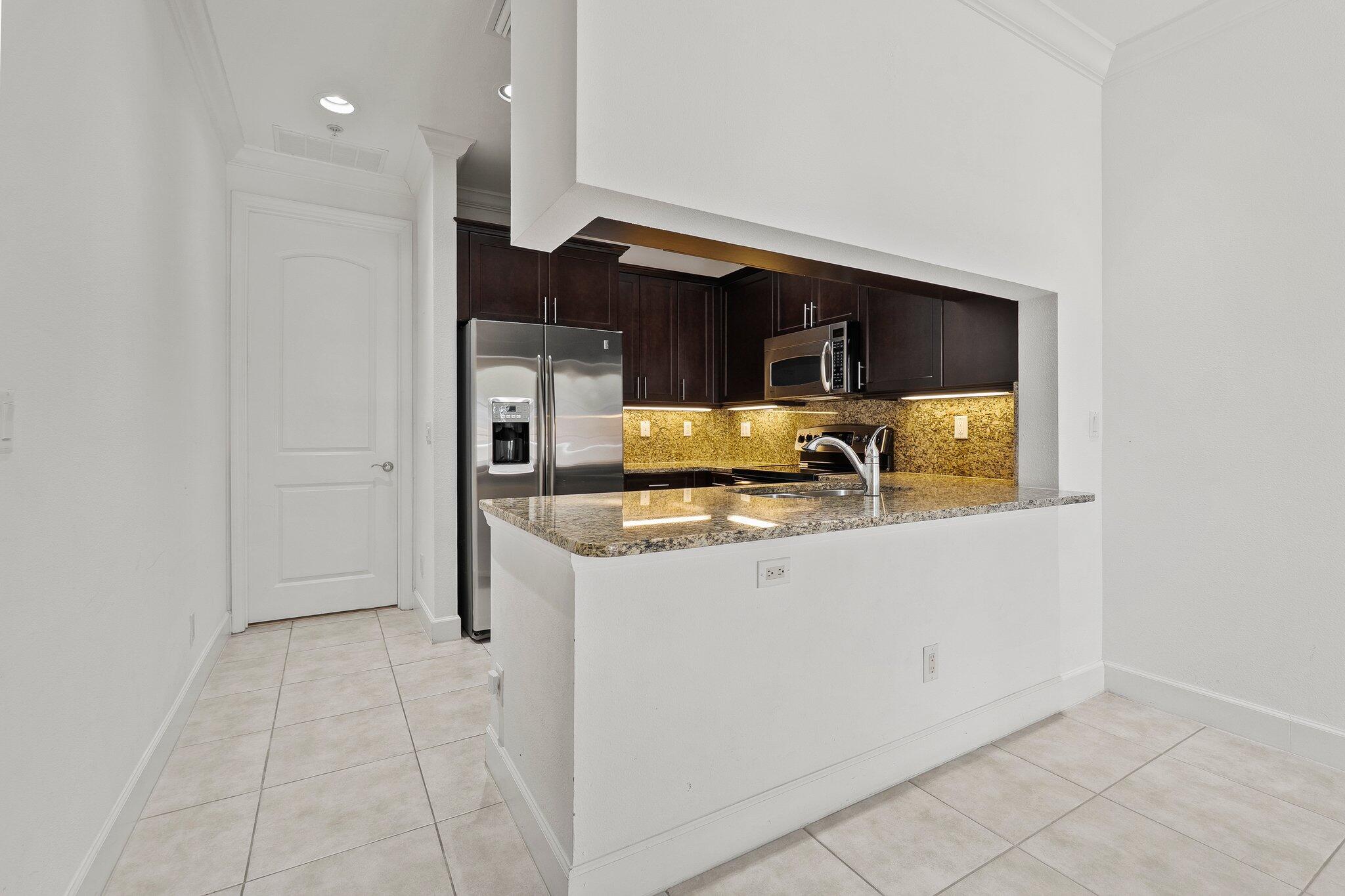1579 Bow Line Road Fort Pierce, FL 34949 - Photo 17 of 56 a view of kitchen with stainless steel appliances granite countertop white cabinets and refrigerator