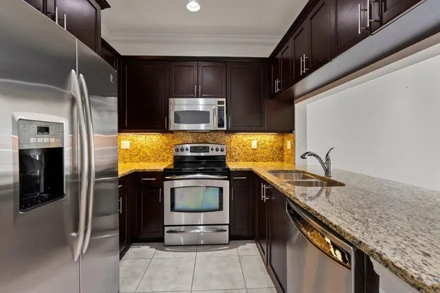 a bedroom with bed and a potted plant