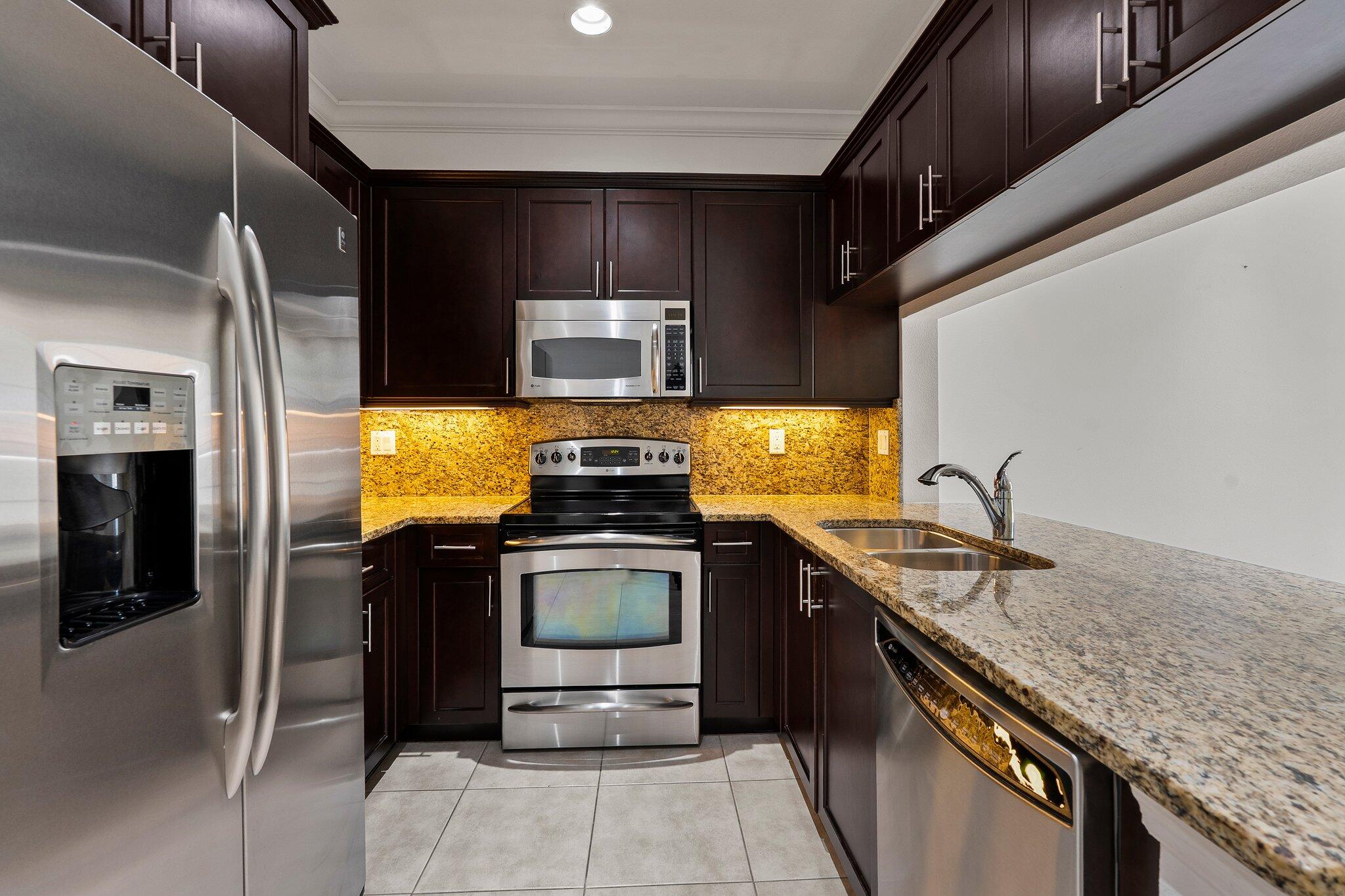1579 Bow Line Road Fort Pierce, FL 34949 - Photo 18 of 56 a kitchen with stainless steel appliances granite countertop a sink and a stove