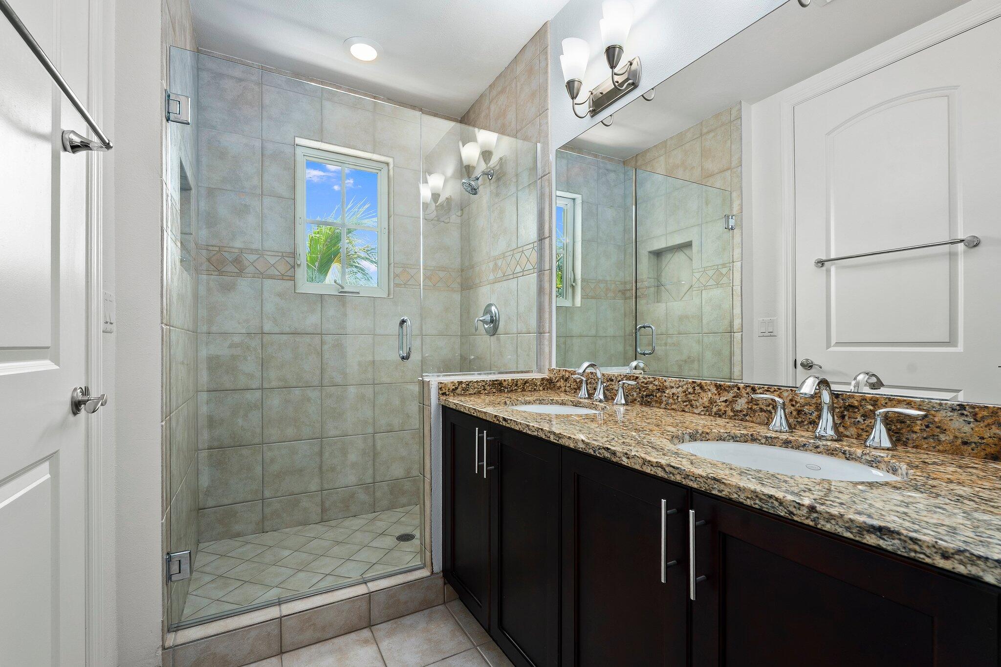 1579 Bow Line Road Fort Pierce, FL 34949 - Photo 24 of 56 a bathroom with a granite countertop sink a mirror a glass door shower and a mirror