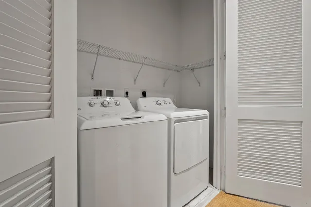 an empty room with an entryway and closet area