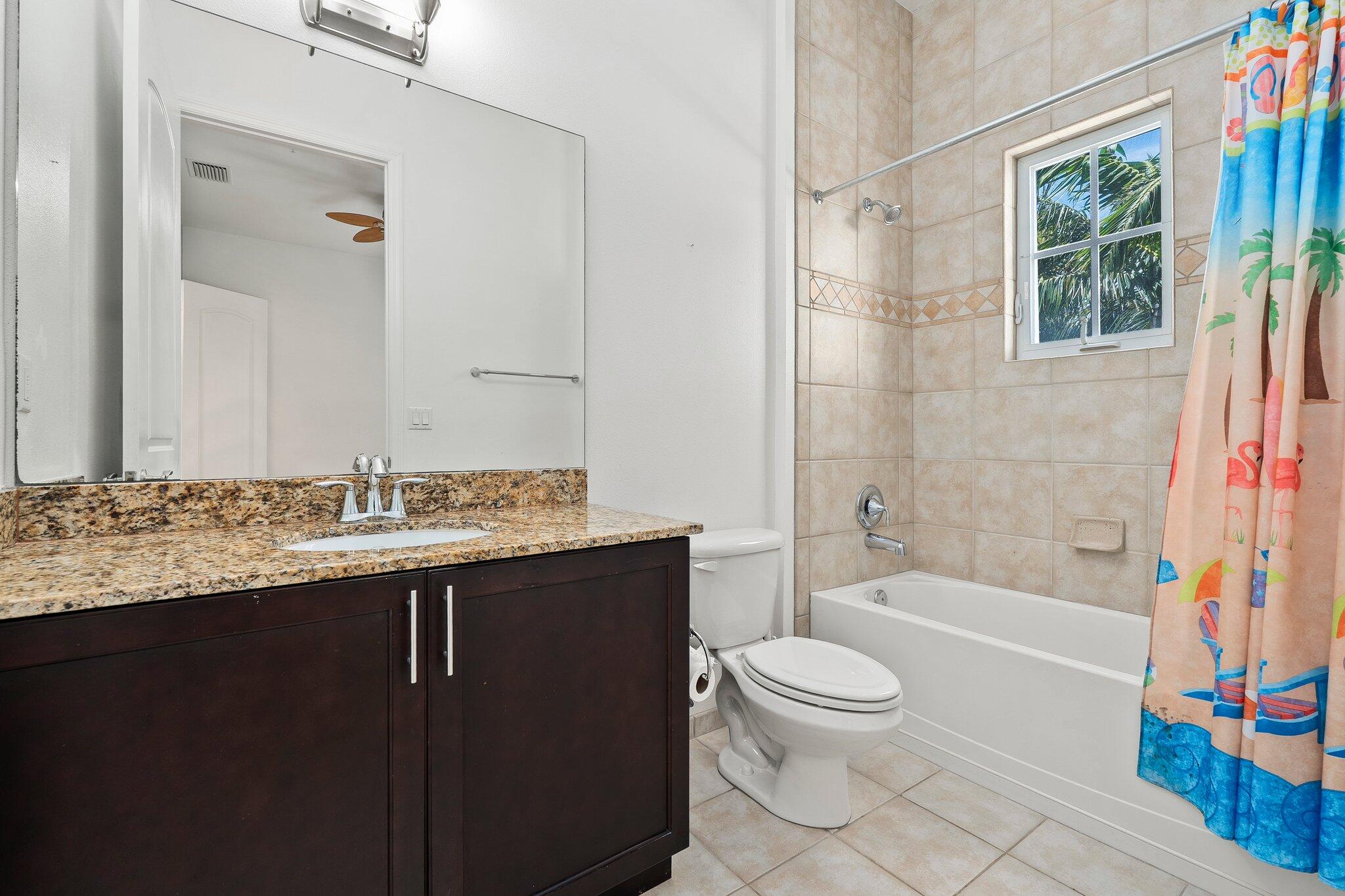 1579 Bow Line Road Fort Pierce, FL 34949 - Photo 27 of 56 a bathroom with a granite countertop sink a toilet and shower