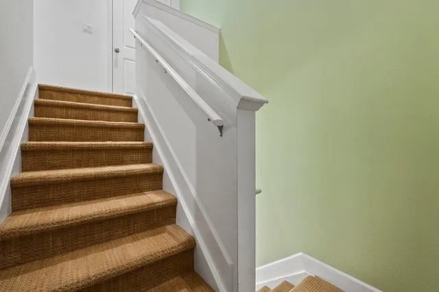 a view of a room with a bed and a window