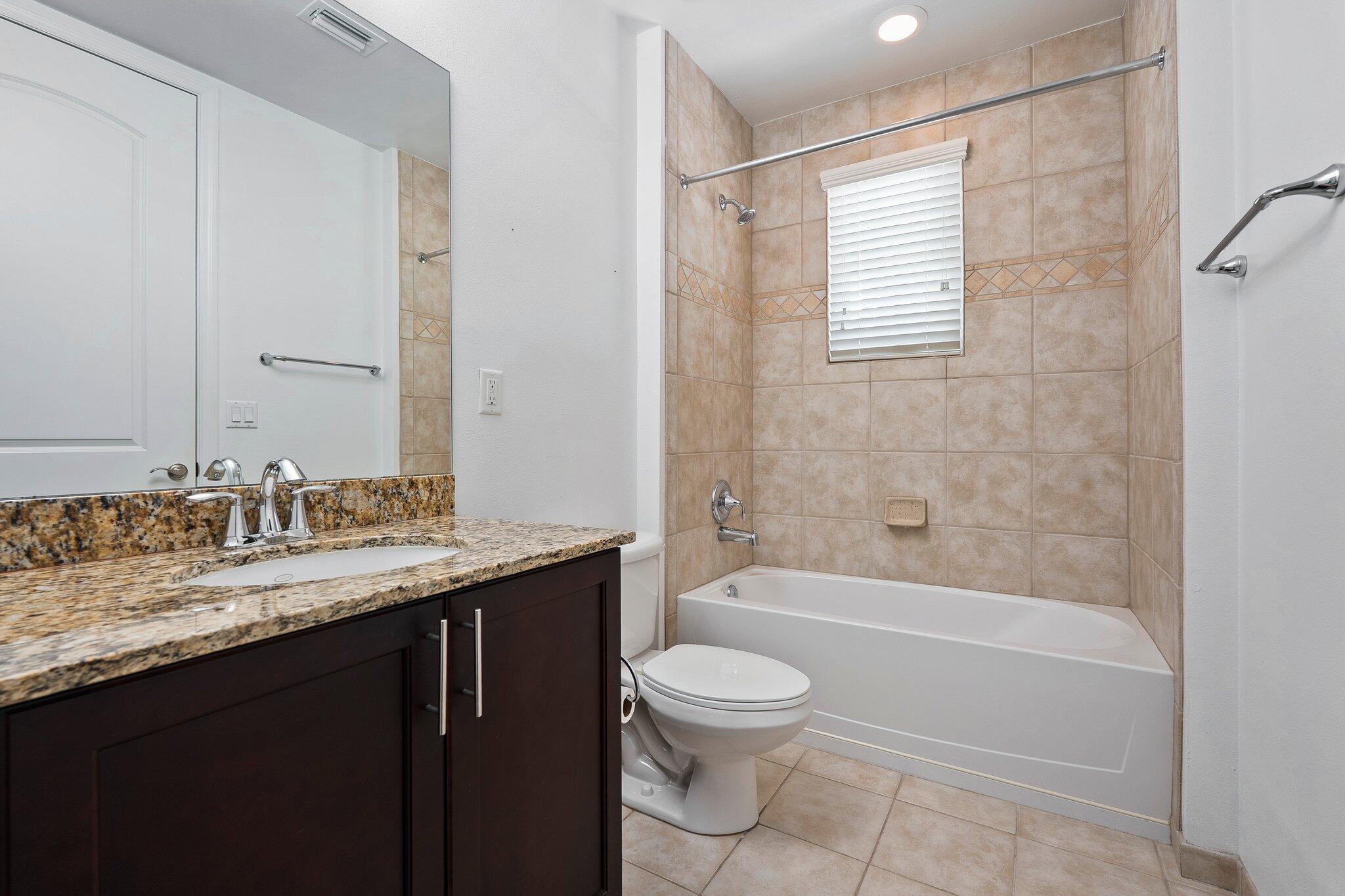 1579 Bow Line Road Fort Pierce, FL 34949 - Photo 34 of 56 a bathroom with a granite countertop sink toilet and shower