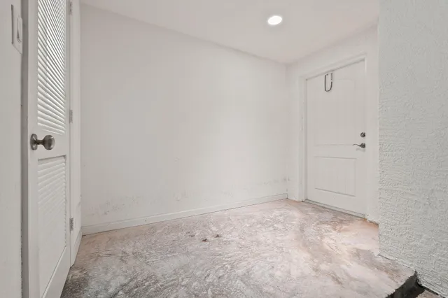 a view of a yard with plants and palm trees