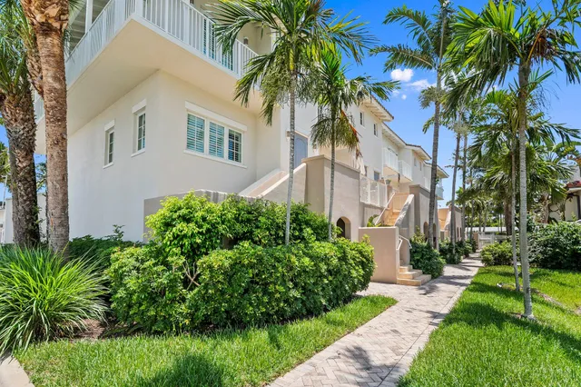 a view of a balcony with dining table & chairs