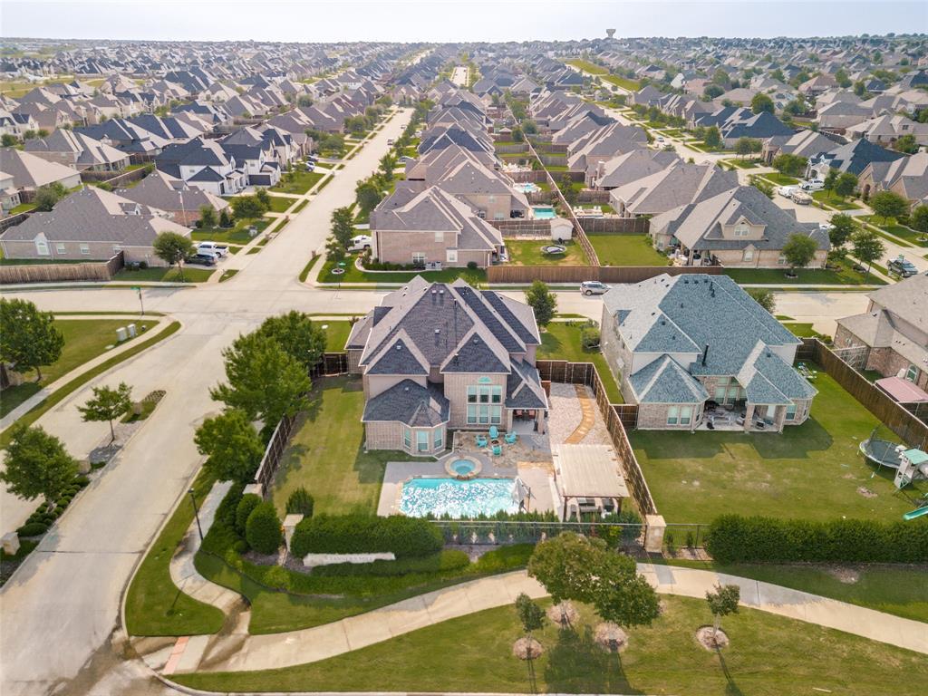 1461 Ramsbury Lane Prosper, TX 75078 - Photo 28 of 30 Expansive backyard featuring a rectangular swimming pool, integrated spa, and a covered patio area with a pergola