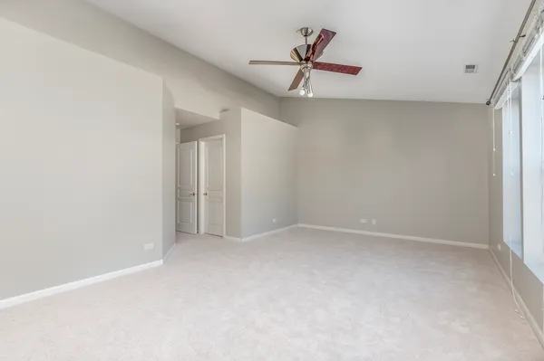 a view of empty room with ceiling fan