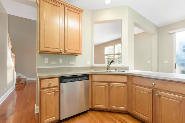 a kitchen with white cabinets and sink