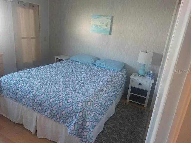 a bedroom with a bed and a rug