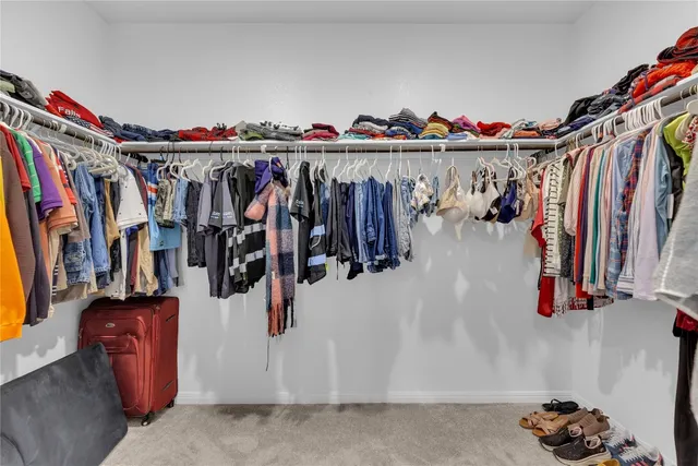 a bathroom with a granite countertop sink a mirror and shower
