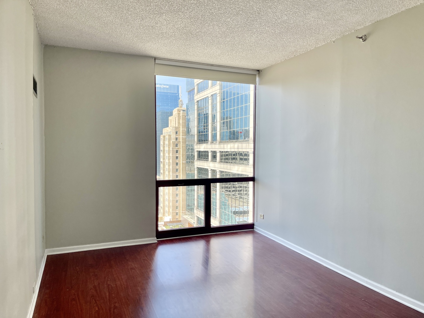 200 North Dearborn Street, Unit 4608 Chicago, IL 60601 - Photo 12 of 26 an empty room with wooden floor and windows