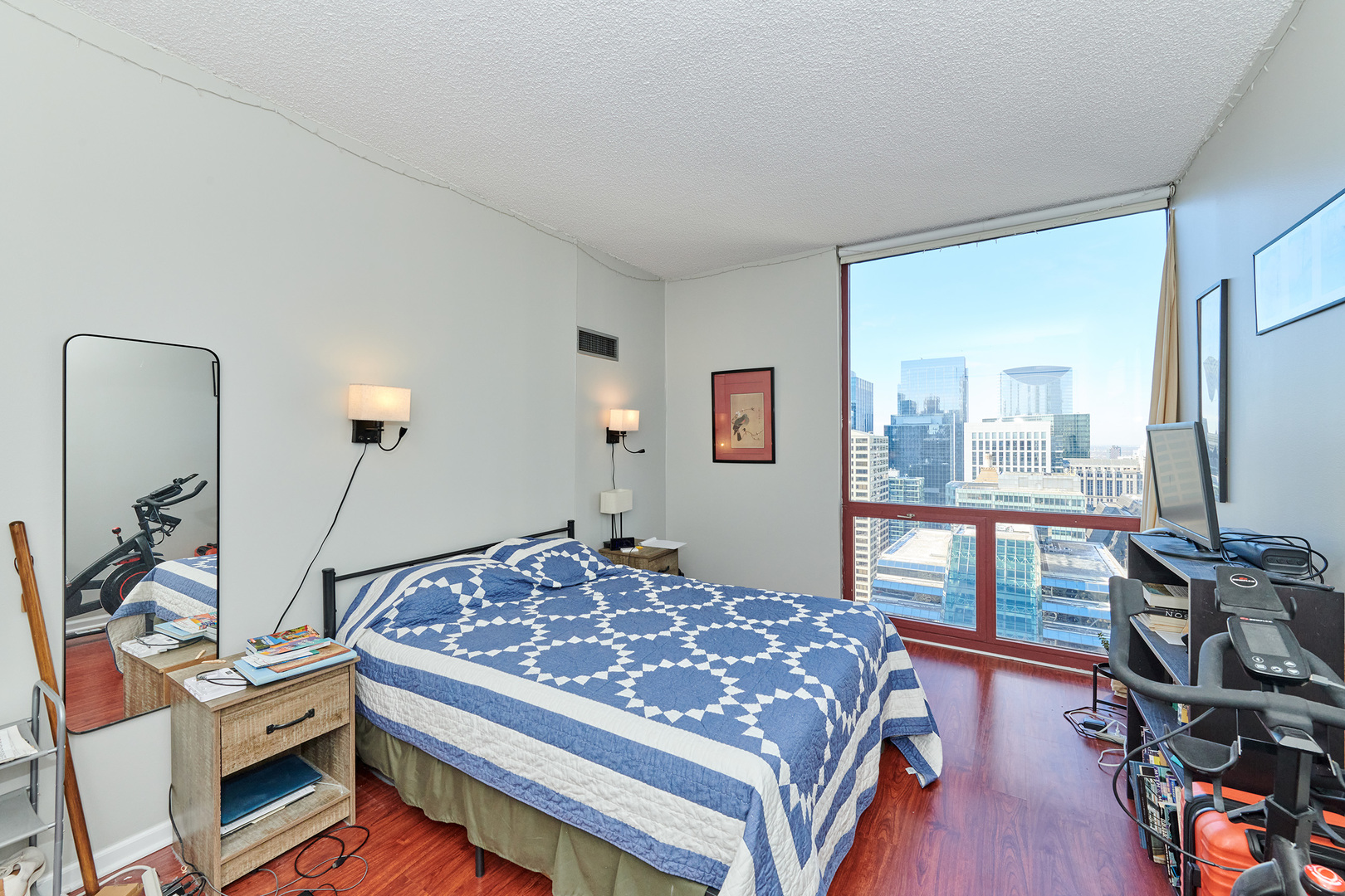 200 North Dearborn Street, Unit 4608 Chicago, IL 60601 - Photo 14 of 26 a bedroom with a bed and a flat tv screen on the dresser
