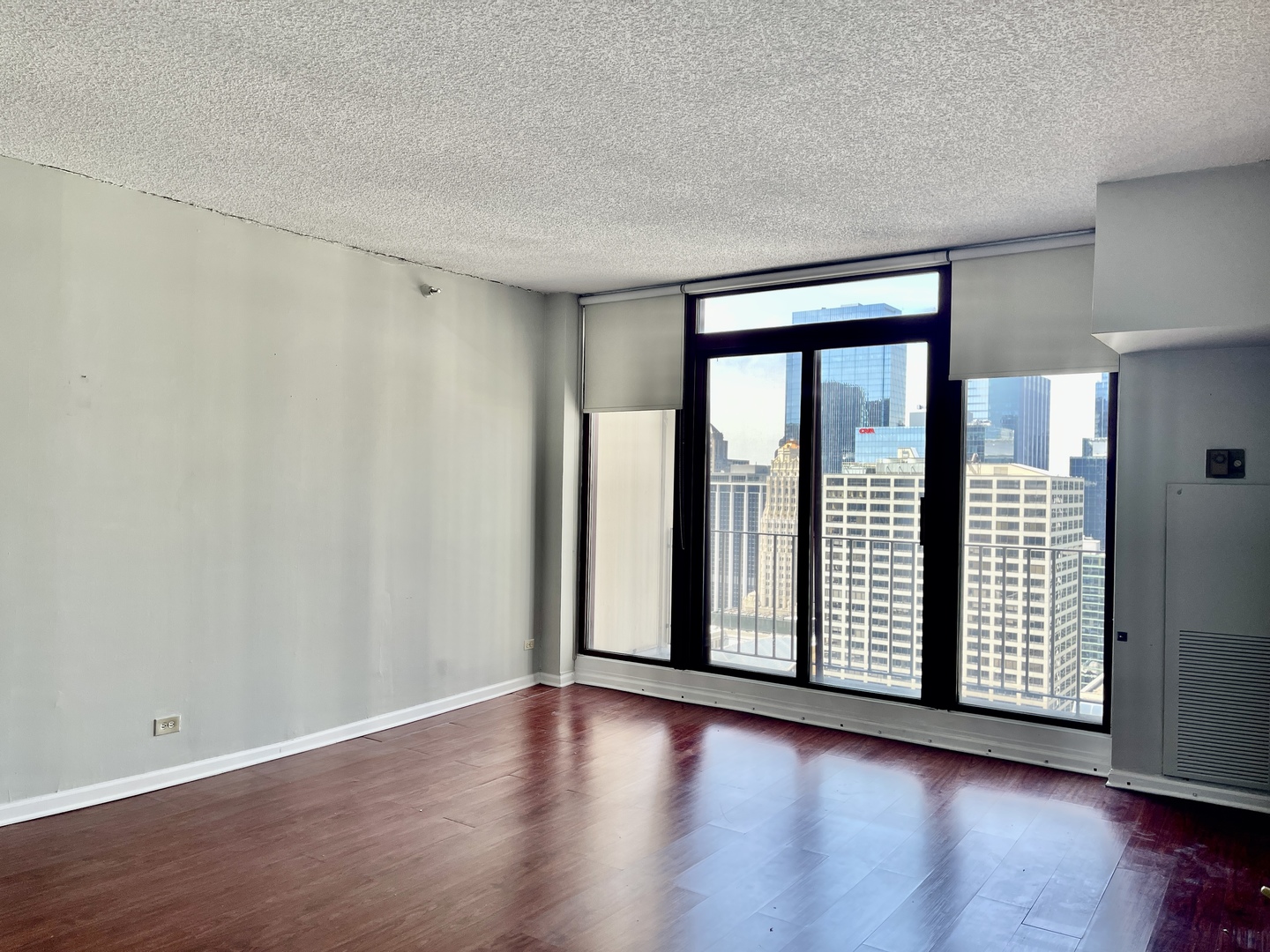 200 North Dearborn Street, Unit 4608 Chicago, IL 60601 - Photo 5 of 26 a view of an empty room with wooden floor and a window