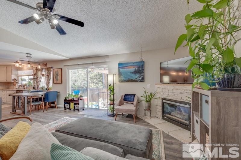 2375 Keystone Avenue Reno, NV 89503 - Photo 8 of 26 a living room with furniture a fireplace a potted plant and a large window