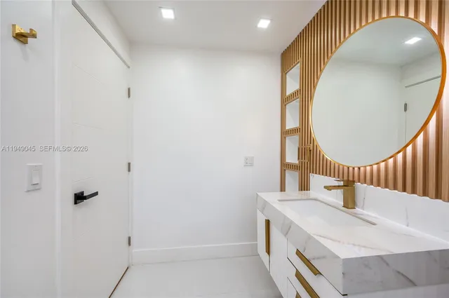 a bathroom with a sink a mirror and a shower