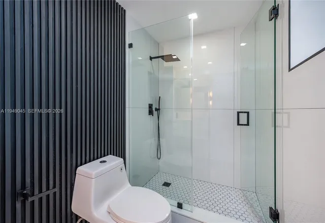 a white toilet sitting next to a bathroom sink