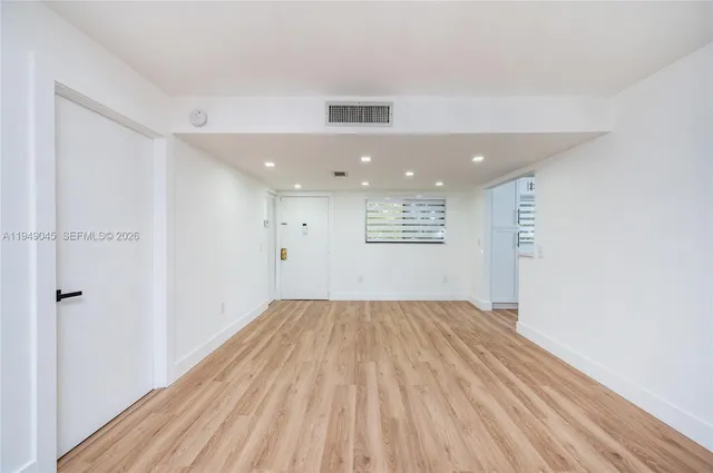 a view of an empty room and a window