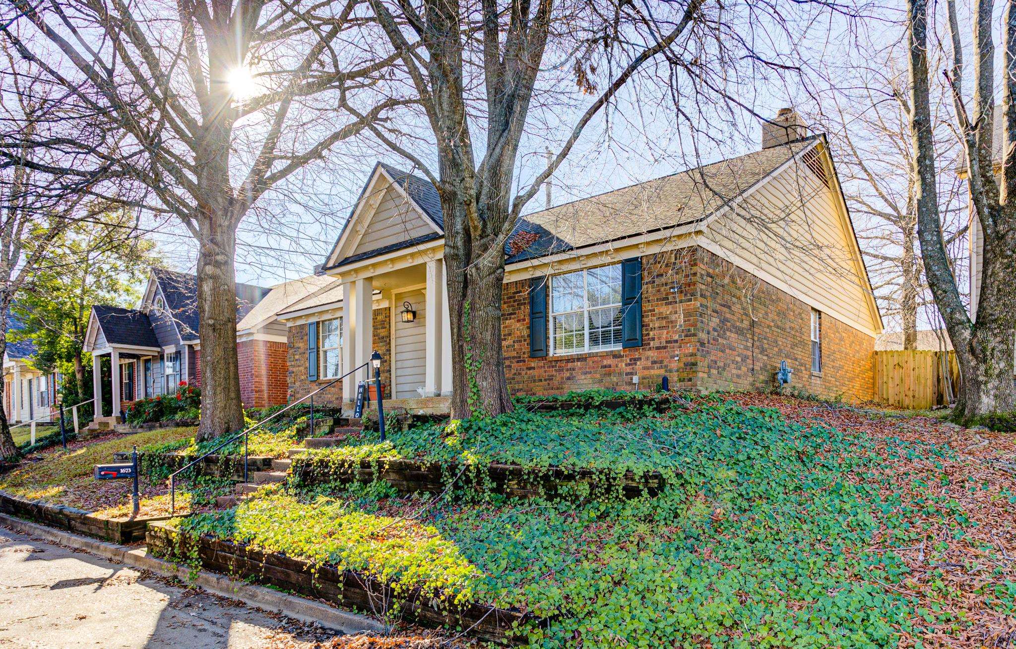 1673 Ranmar Drive Memphis, TN 38016 - Photo 2 of 16 a view of a yard with plants and large trees