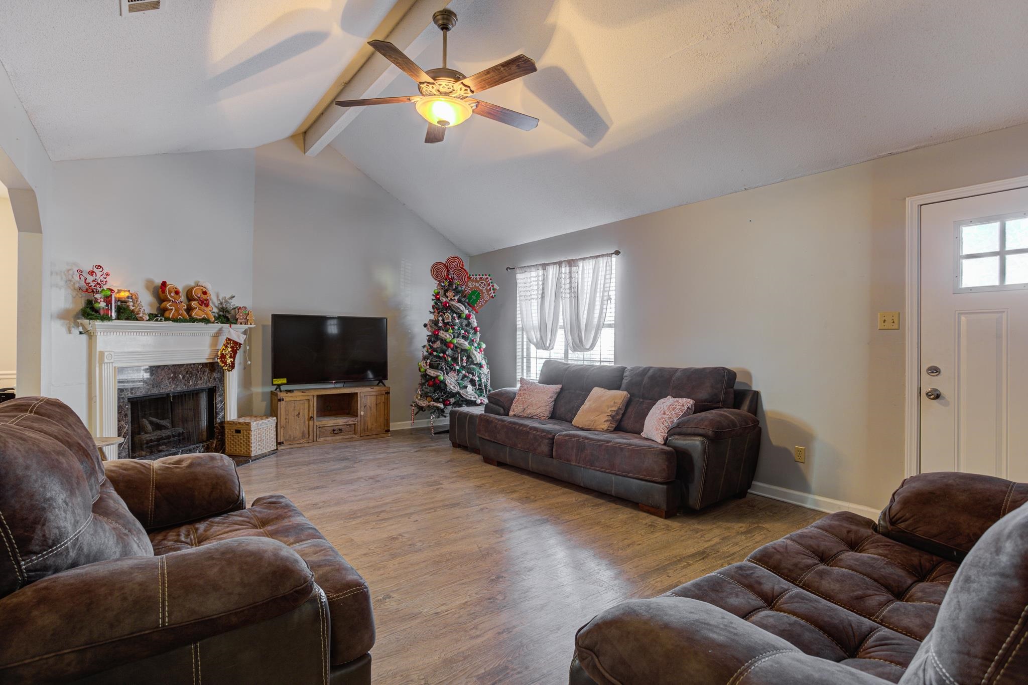 1673 Ranmar Drive Memphis, TN 38016 - Photo 4 of 16 a living room with furniture a fireplace and a flat screen tv