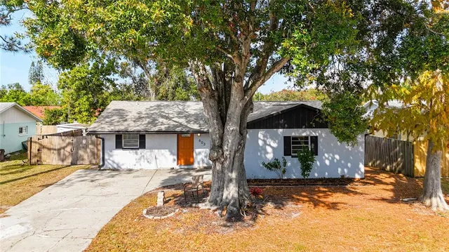 a view of a house with backyard porch and sitting area