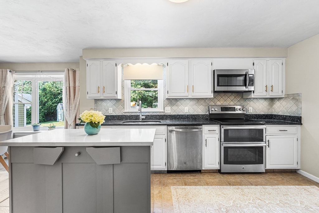 1 Jonathans Way Upton, MA 01568 - Photo 11 of 42 a kitchen with stainless steel appliances a stove a sink a microwave a refrigerator and cabinets