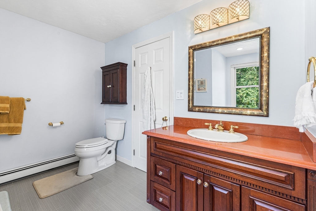 1 Jonathans Way Upton, MA 01568 - Photo 23 of 42 a bathroom with a toilet sink and mirror