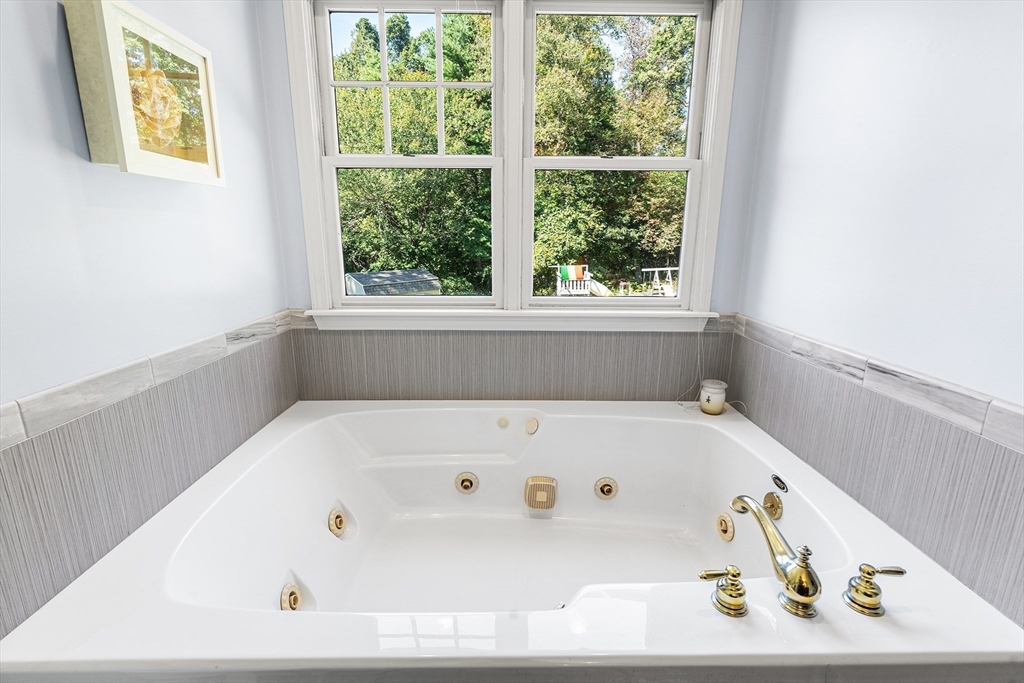 1 Jonathans Way Upton, MA 01568 - Photo 24 of 42 a white bath tub sitting in a bathroom next to a window