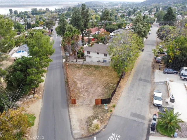 an aerial view of a house with a yard and lake view