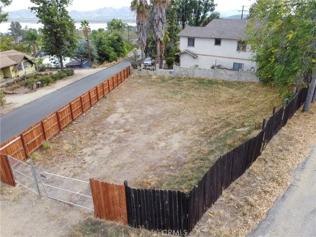 a view of a pathway with a wrought wooden bridge