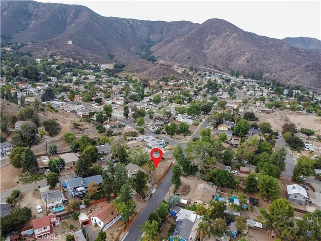 a view of a lush green hillside and houses