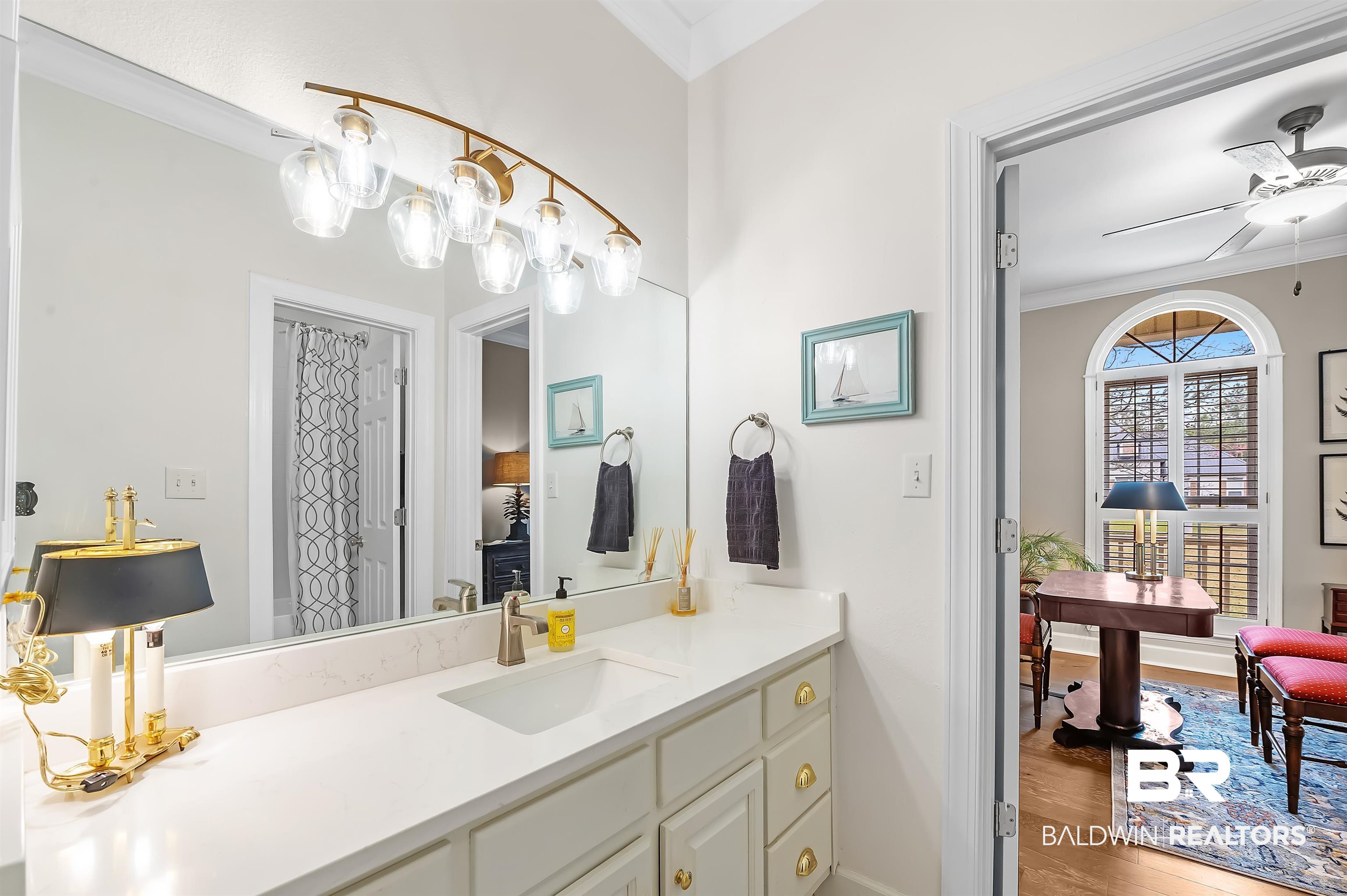 8915 Bay Point Drive Elberta, AL 36530 - Photo 36 of 74 Bathroom with ornamental molding, ensuite bath, wood finished floors, and a ceiling fan