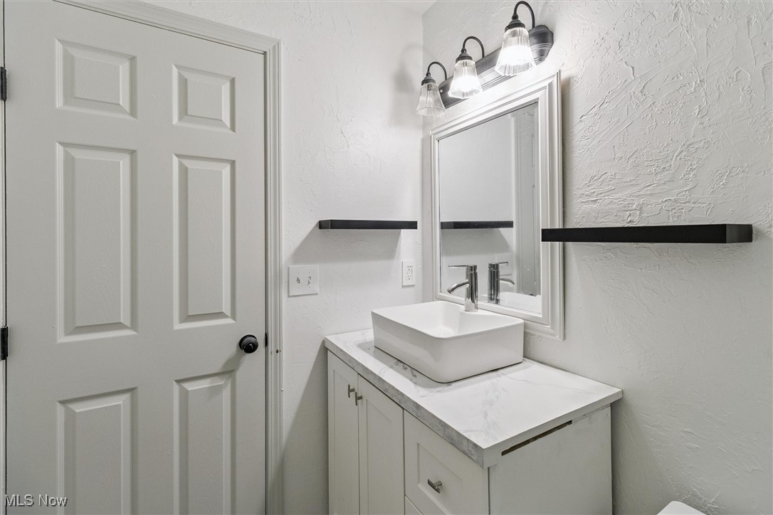 3930 Wood Road Madison, OH 44057 - Photo 39 of 45 Half bath featuring a textured wall and vanity