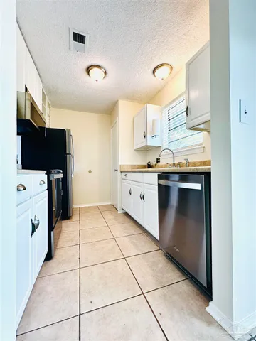 a kitchen with stainless steel appliances a stove a sink and a refrigerator