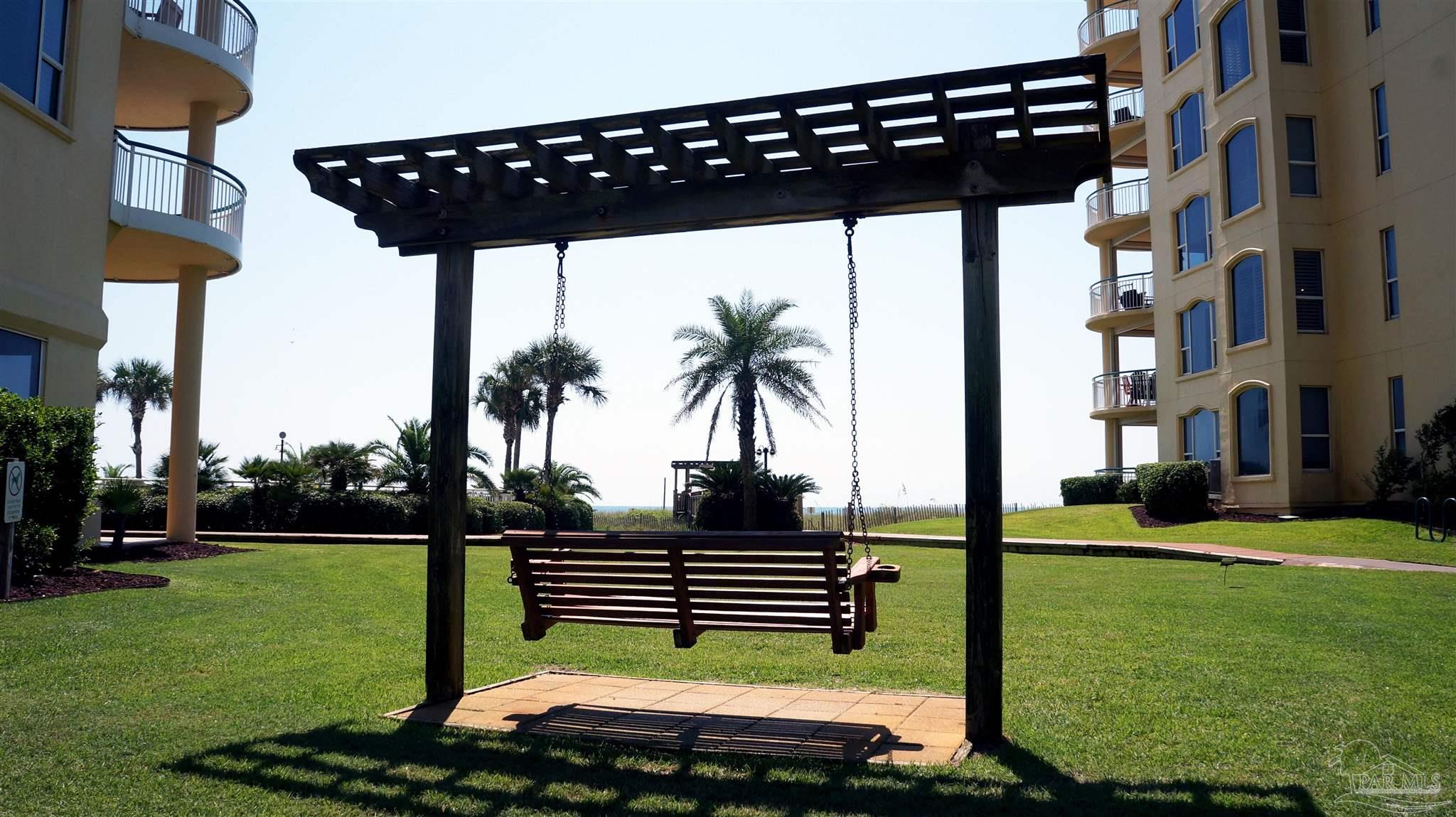 13597 Perdido Key Drive, Unit E12C Pensacola, FL 32507 - Photo 16 of 43 a backyard of a house with lots of green space