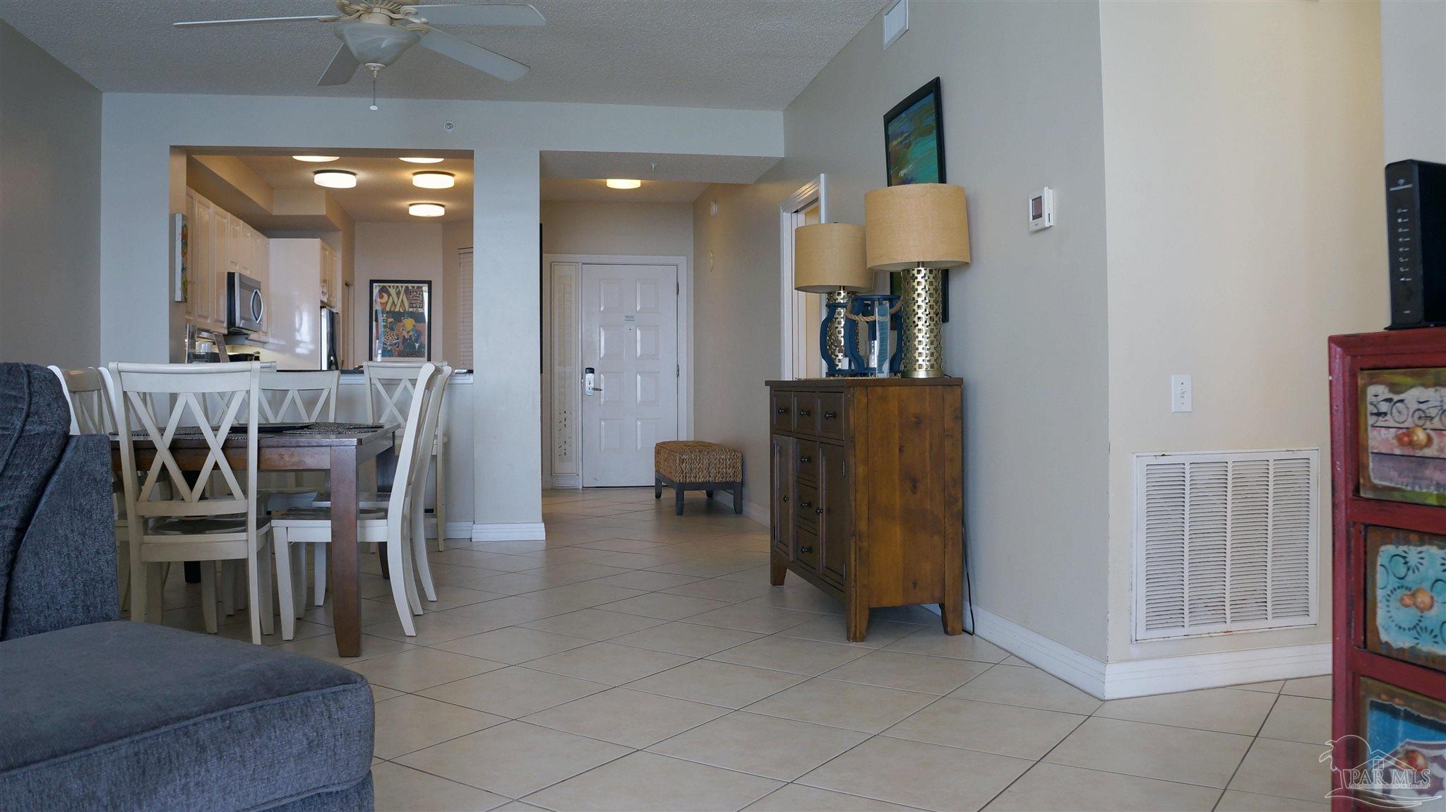 13597 Perdido Key Drive, Unit E12C Pensacola, FL 32507 - Photo 20 of 43 a dining room with furniture and a chandelier