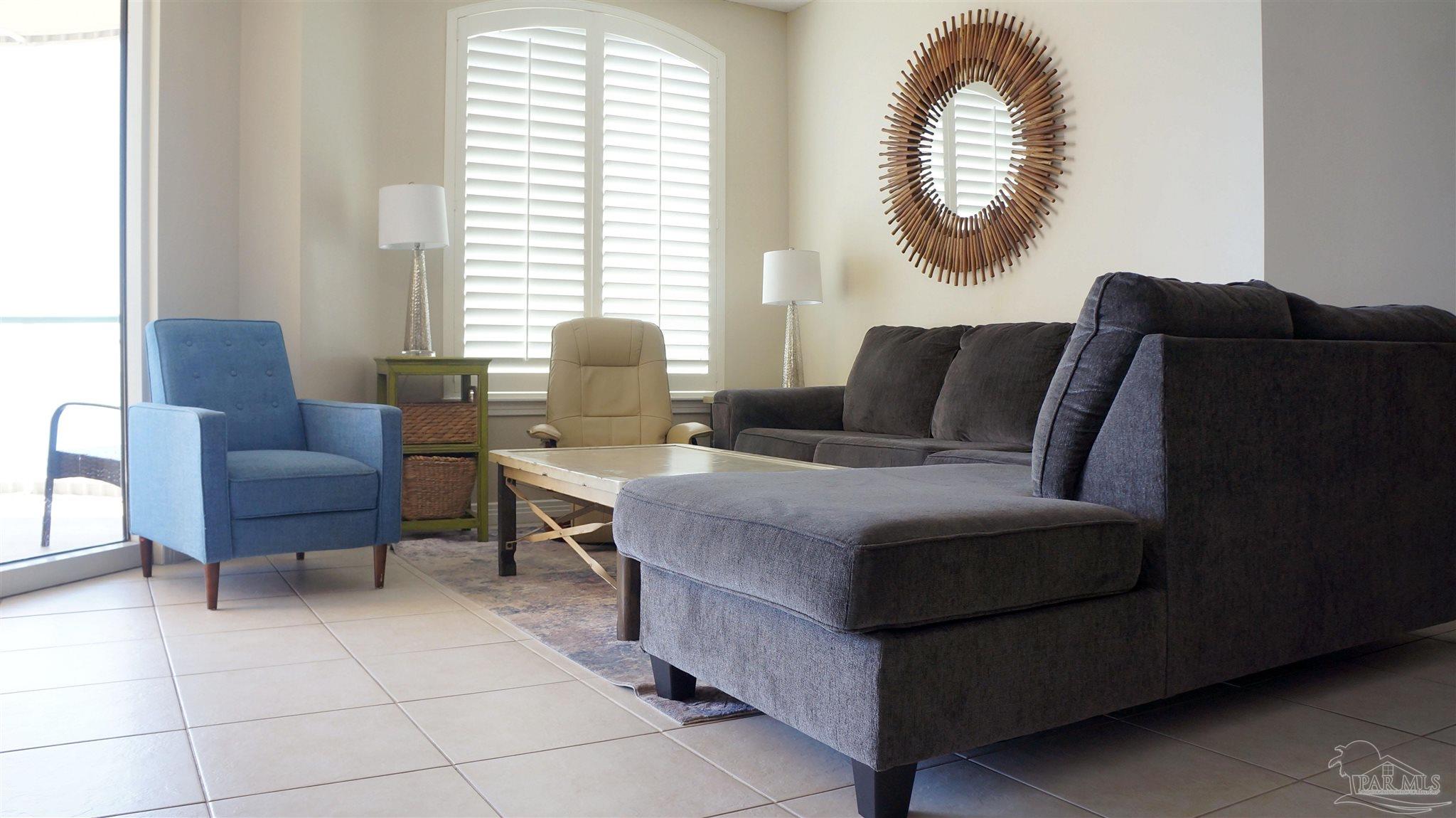 13597 Perdido Key Drive, Unit E12C Pensacola, FL 32507 - Photo 22 of 43 a living room with furniture and a window